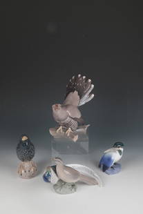 Four Birds: Four Birds Bing & Gröndahl and Royal Copenhagen, Copenhagen, 1920s Various bird depictions on branch or rock pedestals. Polychrome decorated in underglaze painting. On the underside, all birds