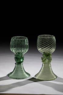 Two Romans: Two Romans German, 18th and 19th centuries Green glass with demolition. Ribbed trumpet foot. Hollow shaft with applied nubs. One cuppa obliquely blown, the other longitudinally optical. H. 13 or 14 cm
