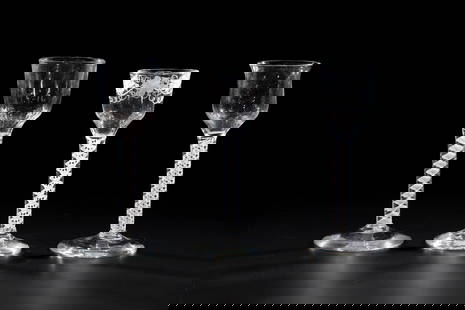 Three thread glasses: Three thread glasses, North German, 18th century, colourless, glass, partly blown longitudinally. Disc base with tear-off. Slender shaft with spirally enclosed frosted glass threads merging into