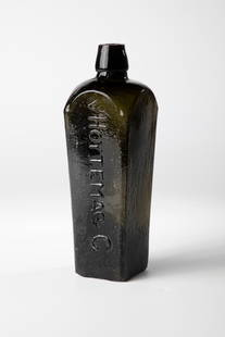 Dutch Gin Bottle: Dutch gin bottle by Hoytema & C., Netherlands 19th century. Dark green glass. Square wall in cross-section, tapering downwards. Short, tapered neck. On one side in relief ''v HOYTEMA & C''. H. 23 cm