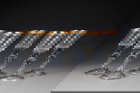 Five Cups: Five goblets Lauenstein, around 1770 Colourless glass with tear-off. Shell foot with folded edge downwards. Hollow baluster shaft. In the base of the cuppa, seven pierced air beads. Gold-plated lip