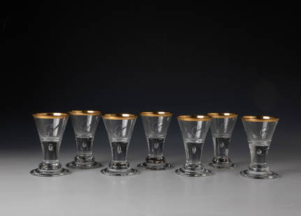 Seven goblets: Seven goblet glasses Lauenstein, c. 1770 Colourless glass. Polished outline with engraved lion mark. Stepped foot damaged on two lenses. Solid shaft with pierced air bladder. On the conically widened