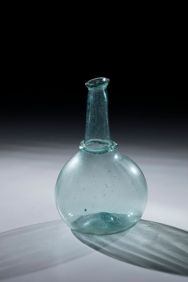 Ball Bottle: Spherical bottle Netherlands or Belgium, 18th century Light green, slightly longitudinally blown glass with tear-off. Glass ring placed at the base of the neck, which tapers upwards. Constricted, warm