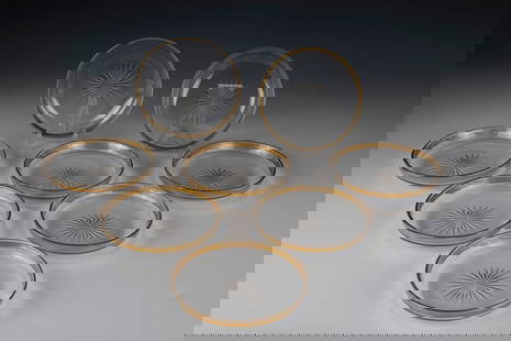 Eight dessert plates: Eight dessert plates, France, 19th century, colourless glass with notched stars and gilt muzzle rims. A plate bumped. D. 14.8 cm