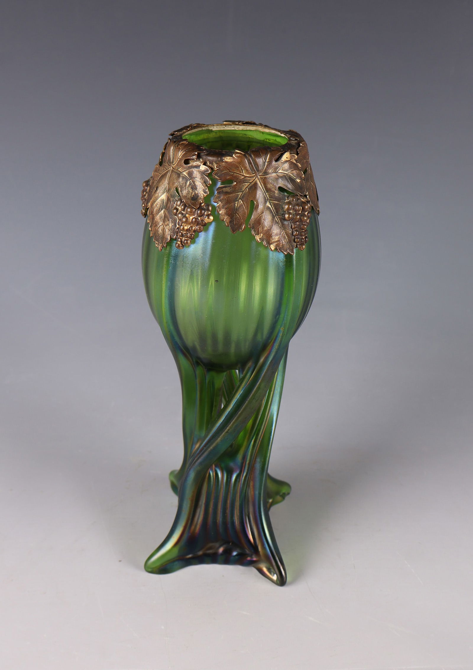 Vase: Vase Loetz Wwe., Klostermühle, c. 1900 Green, longitudinal optical glass. The body is constricted in the middle and four warped ''handles'' pulled out of the wall. Metal mount in the shape of vines.