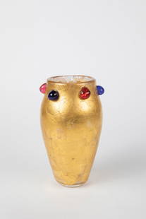 Vase: Vase 20th Century Colorless Glass. On the outer wall, the entire surface is decorated with melted, burst gold foil. 6 applied nubs in blue and red. Signed indistinctly when stationary. H. 21.5 cm.