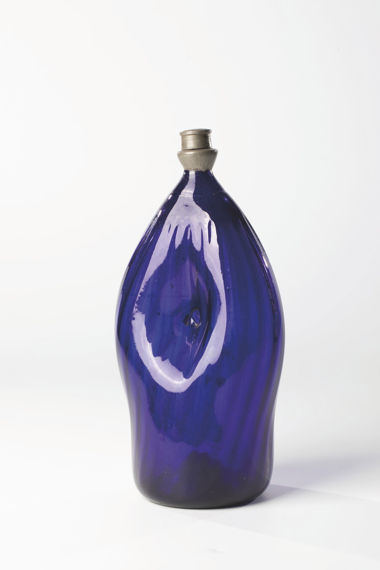 Umbilical bottle: Umbilical bottle Alpine, 18th/19th century Cobalt blue glass. Raised floor with demolition. Centrally bulged, longitudinal optical wall with navel pierced on both sides. Tin screw cap. H. 22 cm