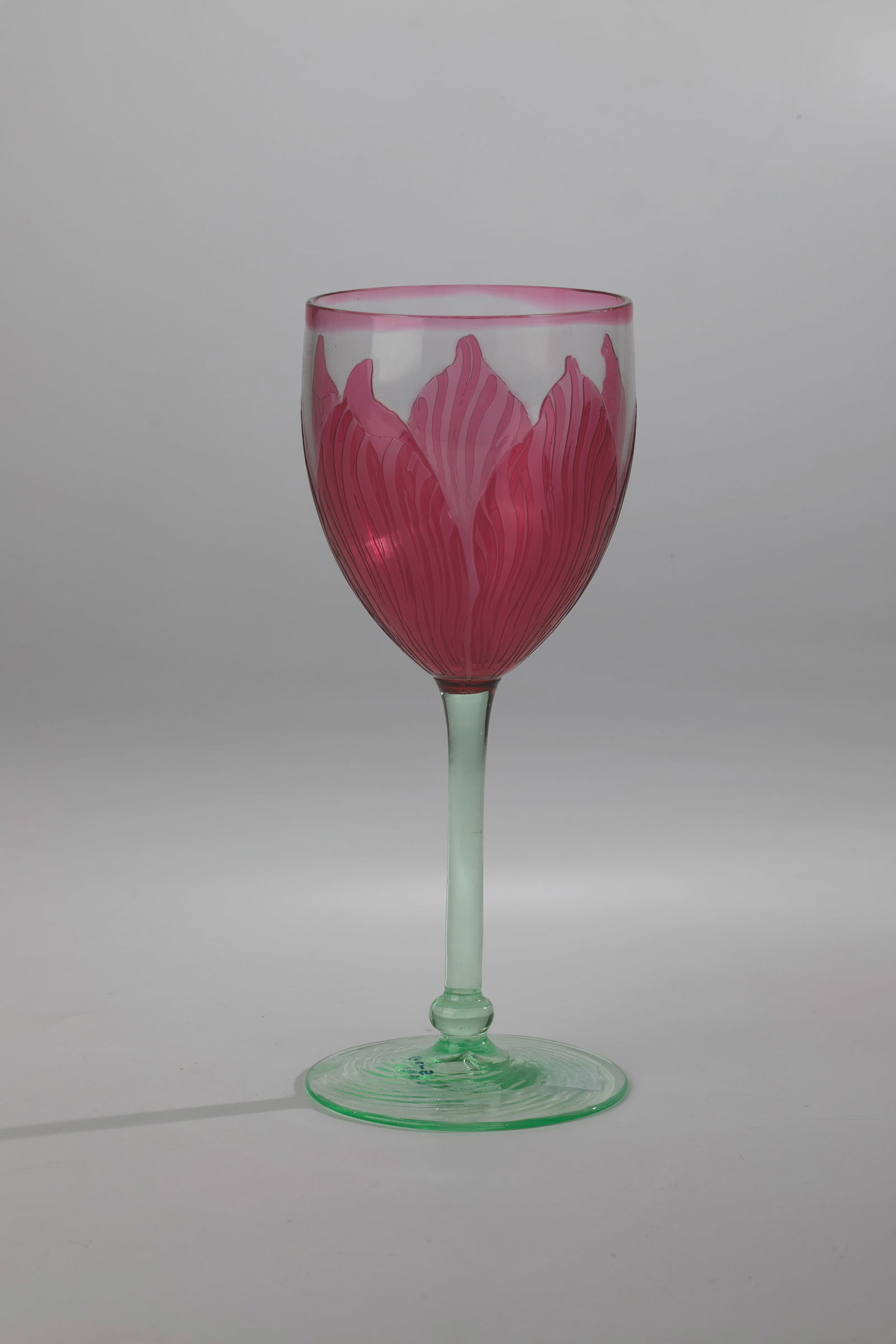 Wine glass: Wine glass Rheinische Glashütten AG, Cologne-Ehrenfeld, c. 1902 Spiral-optically ribbed base and shaft made of lime green glass, overlaid with the colourless cuppa ruby pink. Etched decoration in fiv