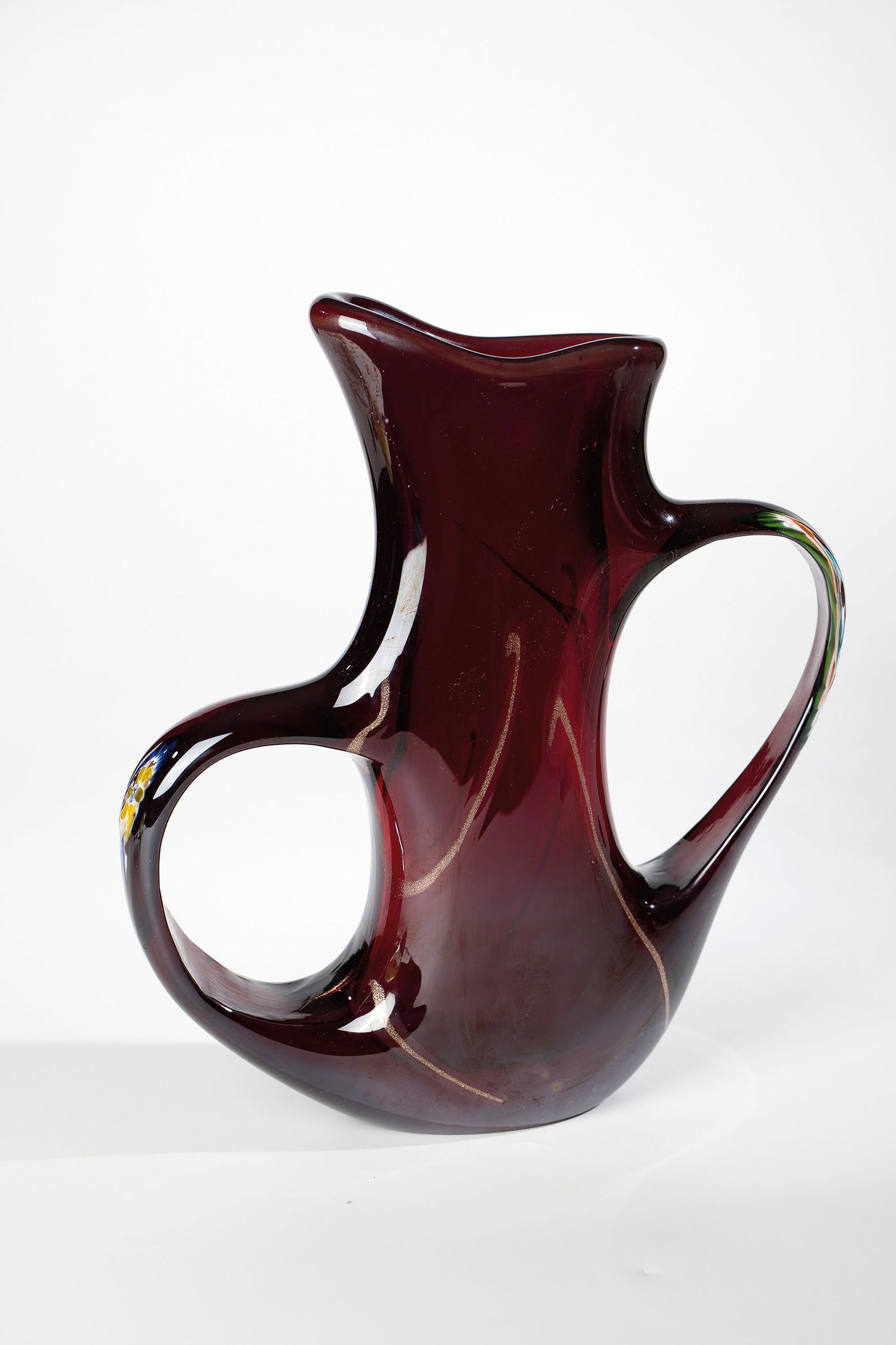 Vase ''anse volanti'': Vase ''anse volanti'' Giorgio Ferro (design), Arte Vetreria Muranese (A.Ve.M.), Murano, c. 1952 Ruby red glass. Wide swinging ribbon handles, with melted polychrome murrine, pulled out of the wall. On