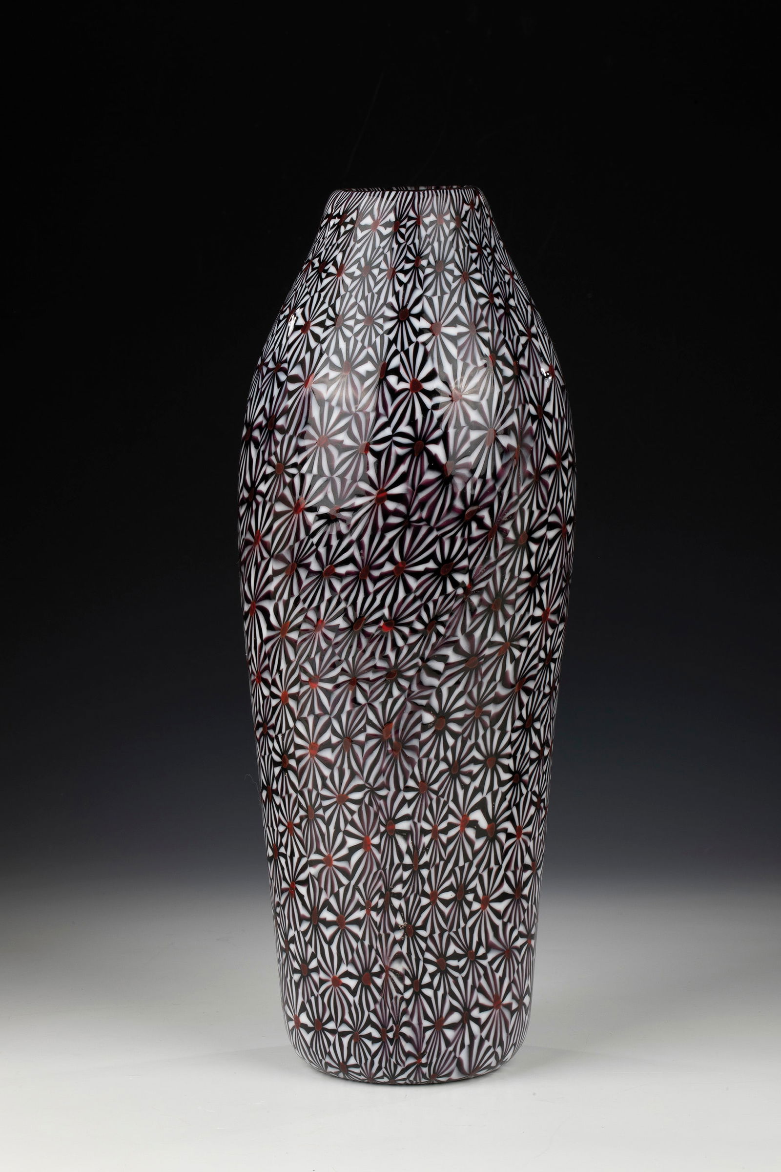 Vase ''Kiku'': Vase ''Kiku'' Ermanno Toso (design), Fratelli Toso, Murano, 1950-55 Colourless glass with melted murrine 'Kiku' in black-violet, white and red. Surface acid-polished. H. 33.5 cm.Please note that this