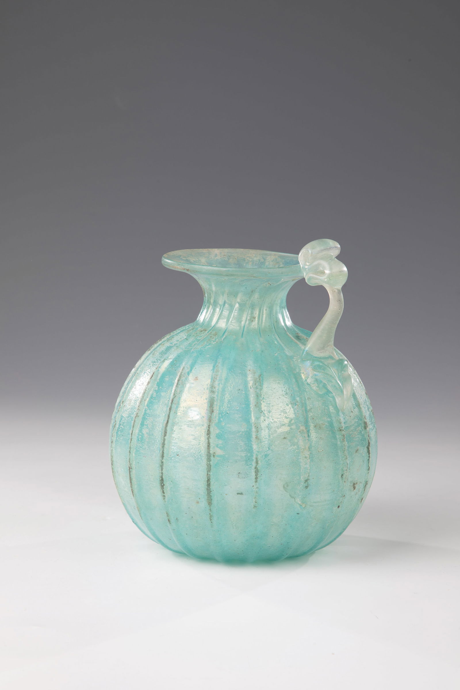 Antique jug: Antique-style jug Murano, late 20th century Colourless glass with turquoise-green powder melting. Rib-optically blown with wide protruding muzzle rim. Attached, freely applied handle pinched with plie