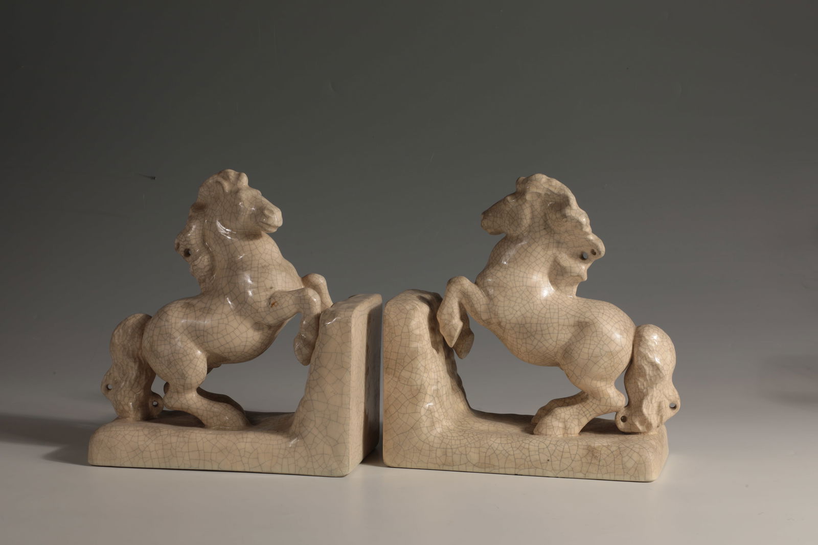 Pair of Bookends: Pair of bookends Michael Powolny (design), Gmundner ceramics, c. 1920 earthenware. Cream-coloured glaze with crackle. Underside inscribed: brown manufactory stamp, 1284, 6 (incised). h. 23 cm. Lit.: E