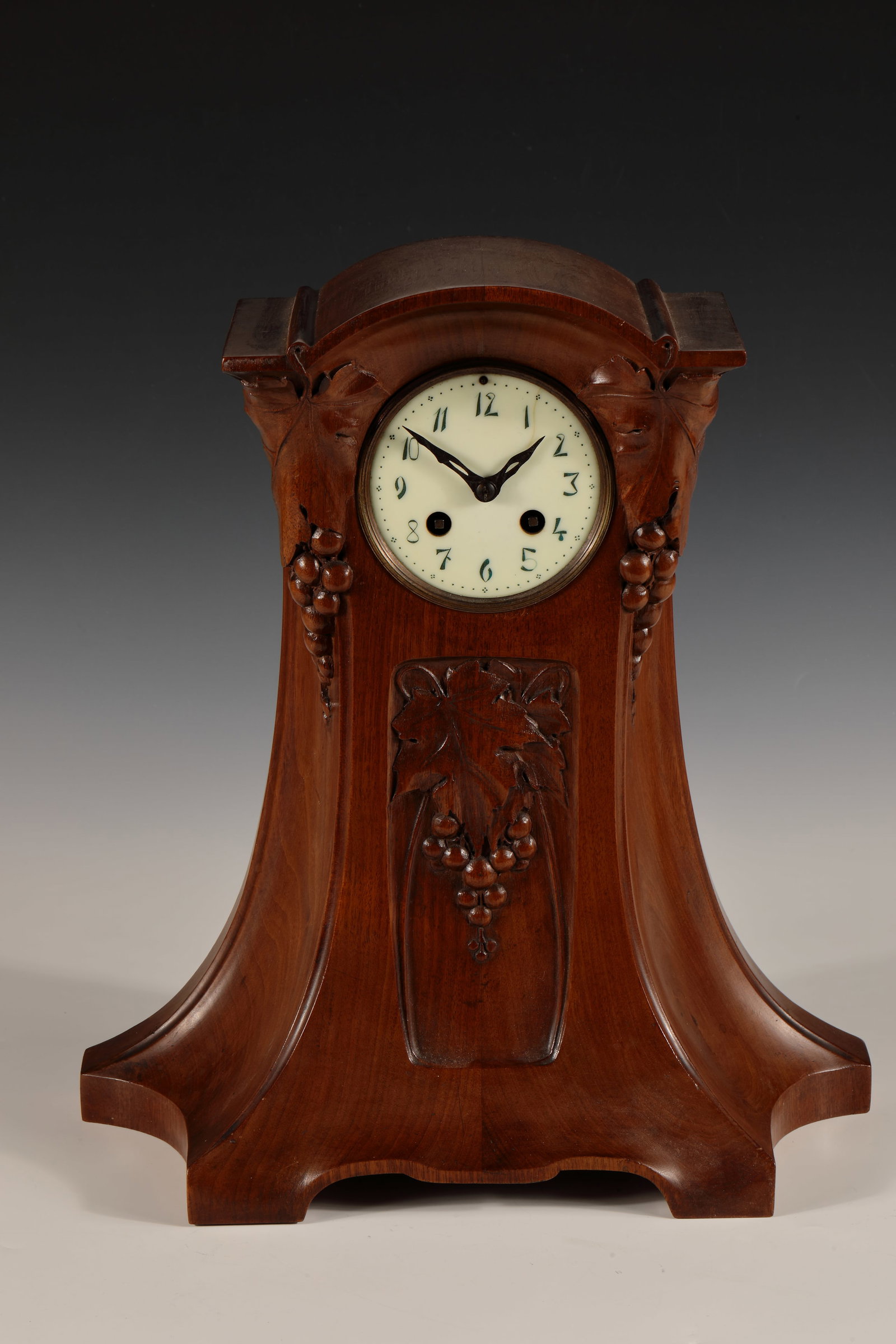 Chest of drawers clock: Chest of drawers clock circa 1900 Curved wooden case with wine décor. White dial with Arabic numerals. Round brass movement with lever gear, pendulum on spring suspension and half-hour strike on gong
