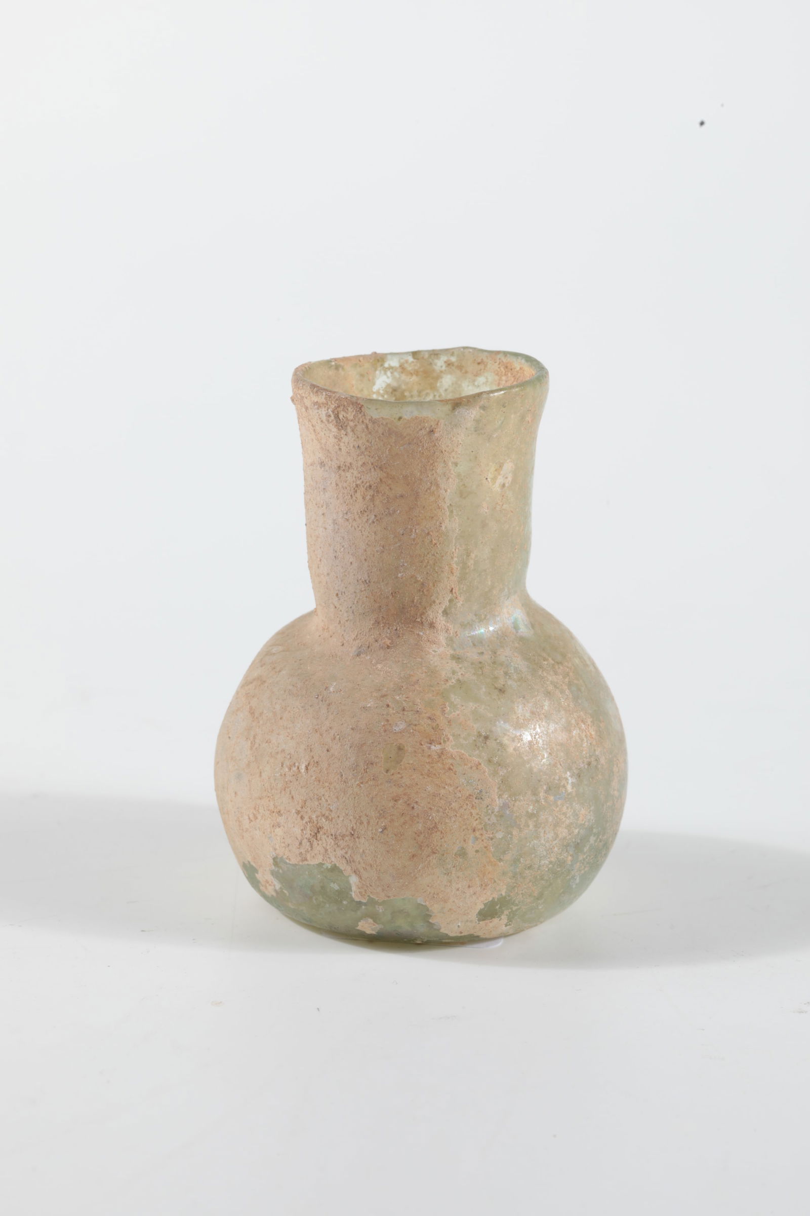 Unguentarium: Unguentarium Eastern Mediterranean, 2nd/3rd century AD Light green glass with sediment adhesion. Bulbous wall, short tubular neck. H. 5 cm