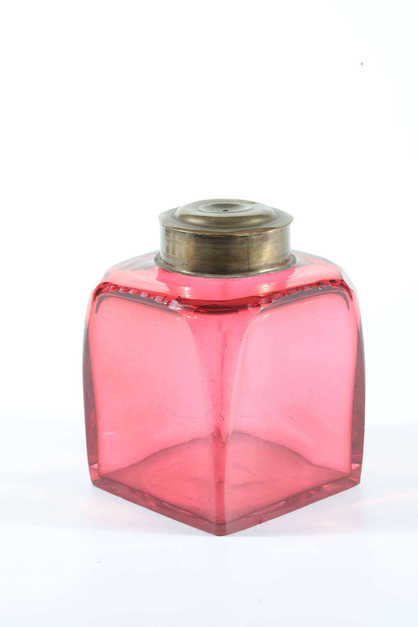 Square bottle with gold ruby underlay: Square bottle with gold ruby underlay Saxony, Johann Friedrich Böttger, Dresden (attributed), c. 1720 Colourless glass with gold ruby underlay, glowing strongly green under UV light. Stand and sides