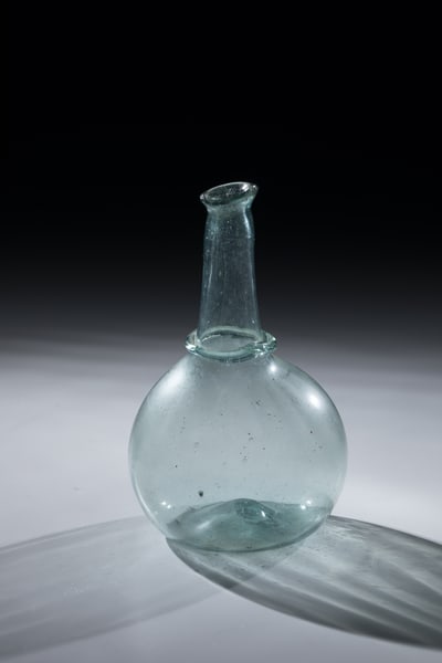 Ball Bottle: Spherical bottle Netherlands or Belgium, 18th century Light green, slightly longitudinally blown glass with tear-off. Glass ring placed at the base of the neck, which tapers upwards. Constricted,