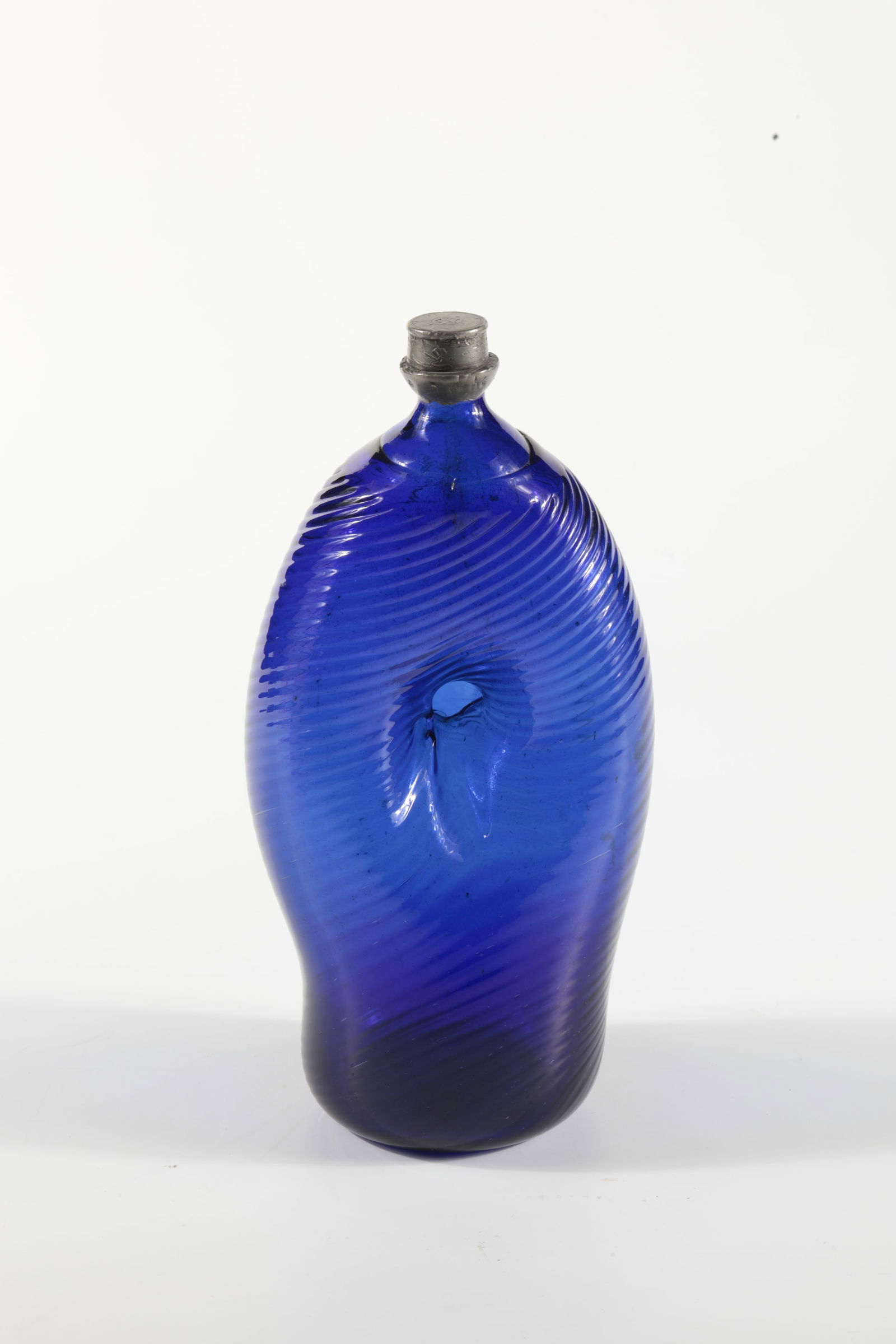 Umbilical bottle with tin screw cap: Umbilical bottle with tin screw cap Alpine, 18th century Cobalt blue, oblique glass blown at an angle with a slightly raised bottom, tear and navel pierced on both sides in the middle. H. 22 cm