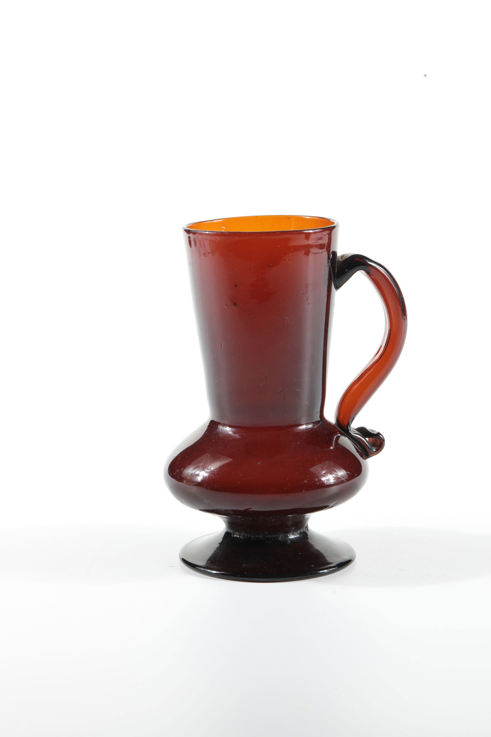 Rare jug with handles: Rare jug with handle, Transylvania, c. 1800, brown glass. Slightly raised disc base with tear-off. Spherical, pressed wall with high, slightly widened neck. Hollow, appliquéd handle with rolled end.