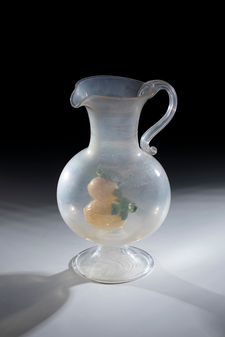 Jug with lemons: Jug with lemons Murano, E.17. A. 18th century Colourless, slightly iridescent glass with tearing. Foot with the edge folded upwards. Inside the bulbous wall with a pressed spout and an appliquéd hand