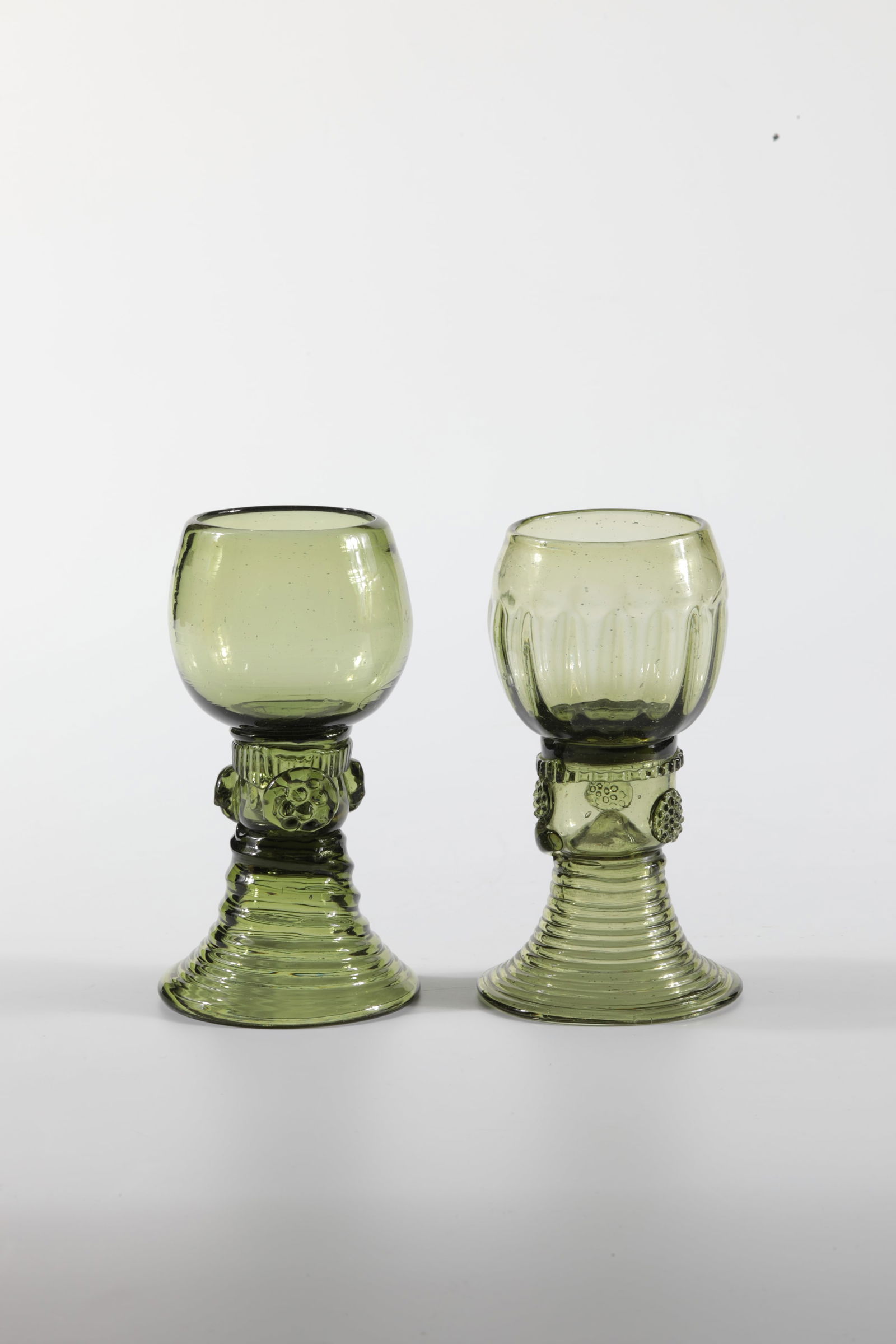 Two Romans: Two Romans German, 19th century Green glass with tear-off. Ribbed trumpet foot. Stock with appliquéd berry nubs. A cuppa ribbed. H. 12 or 12.5 cm