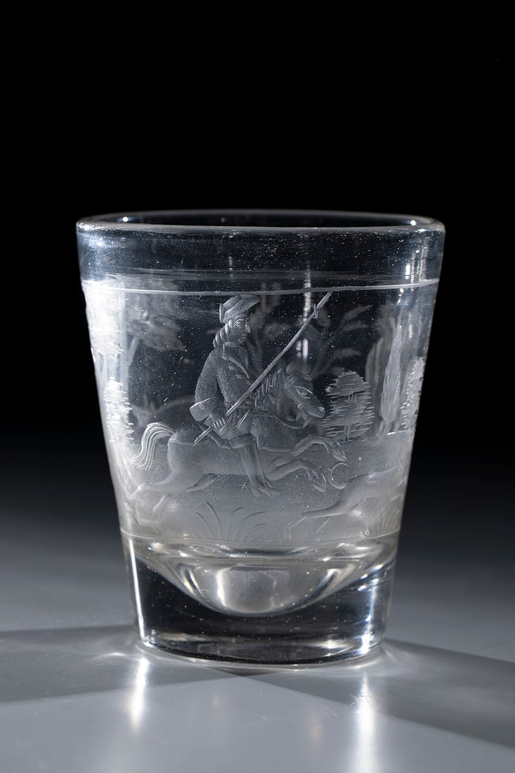 Hunting Mug: Hunting cup Bohemia or Brandenburg, 17th /18th century Colourless glass with polished tear-off. Hunting scene cut on the conically widened wall: riders with boar feathers and dogs hunting a wild boar