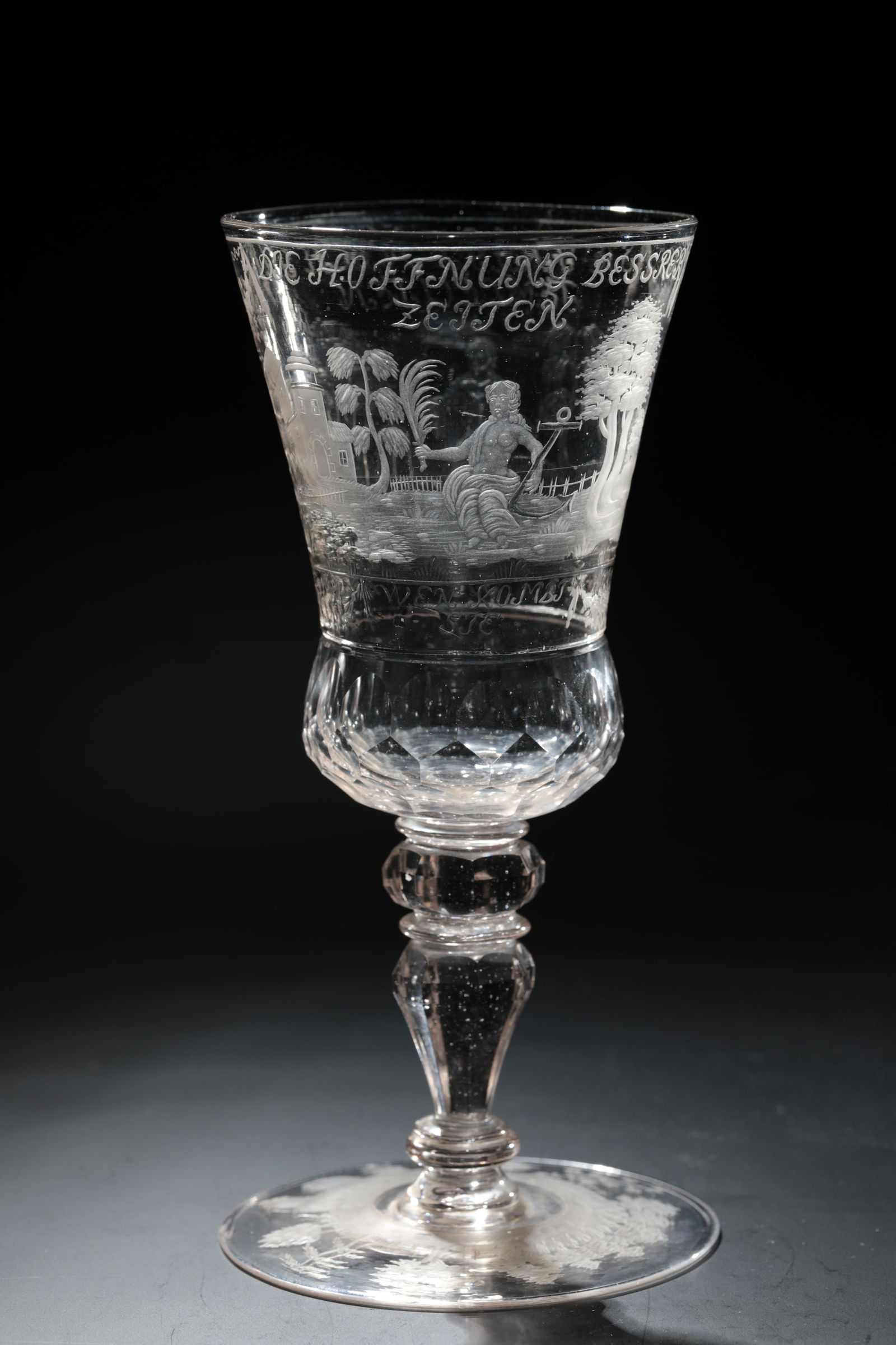 Goblet with Allegory of Hope: Goblet with allegory of hope Saxony, 1st half of the 18th century Colourless glass with tear-off. Architectural staffage cut on the upper side of the disc base in a tree-covered landscape. Baluster