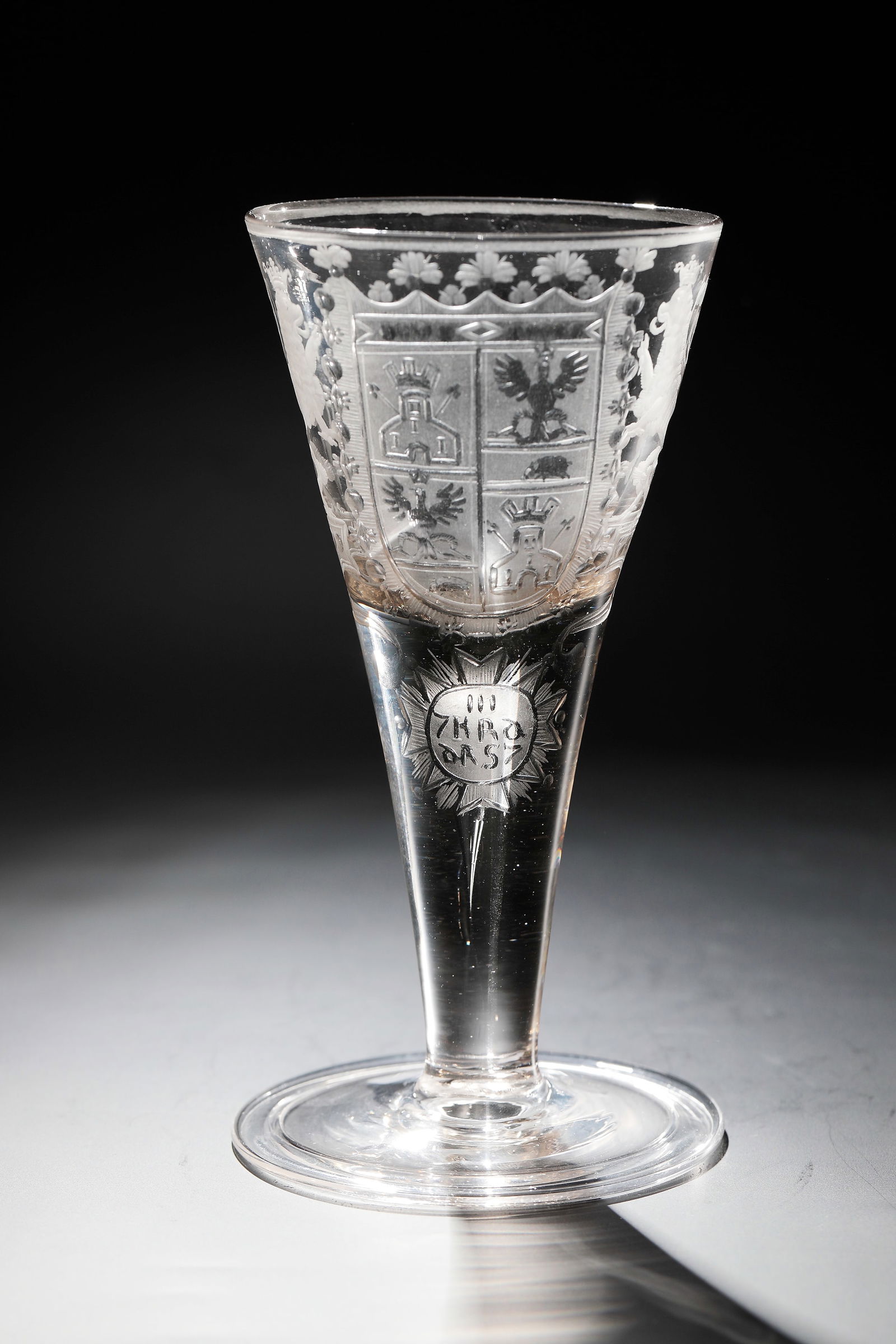 Pointed chalice with coat of arms of Thurn and Taxis: Pointed chalice with coat of arms of Thurn and Taxis Middle German, 1st half of the 18th century. Massive, smooth shaft with a large air bubble tapering downwards. On Kuppa, partly low-cut, partially