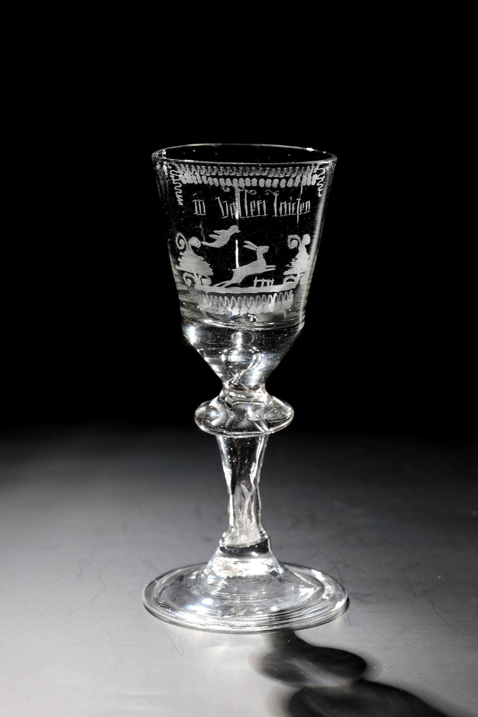Cup with rabbit hunt: Goblet with hare hunt Thuringia, 18th century Colourless glass with tear-off. Disc base with the edge folded downwards. Compressed hollow baluster shaft. Air bubble pierced at the base of the bell-sha