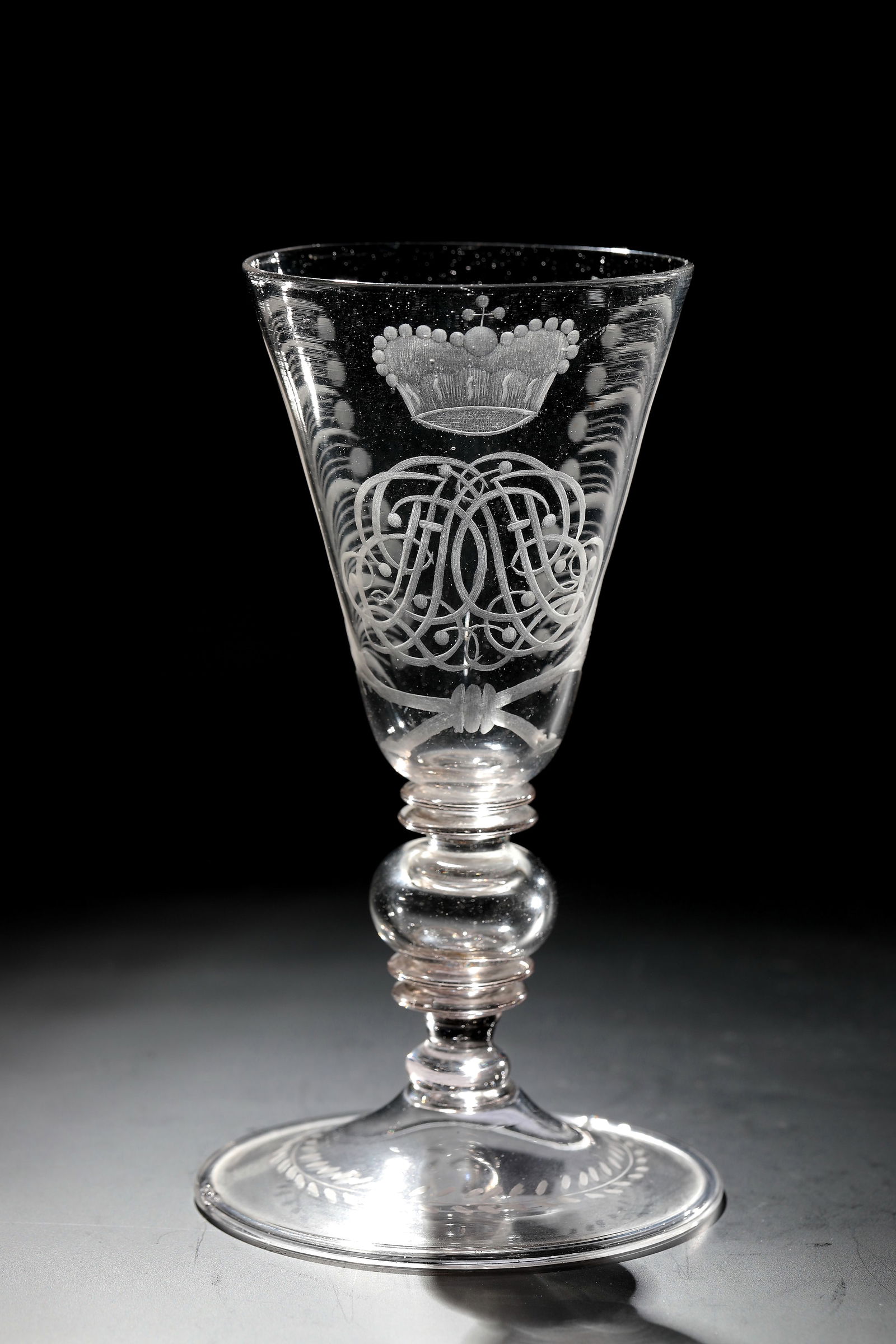 Goblet with princely ligature monogram: Goblet with princely ligature monogram Bohemia, 2nd half of the 18th century Thin-walled, colourless glass with tear-off. Slightly rising disc base with downwards folded edge and leaf border. Shaft co