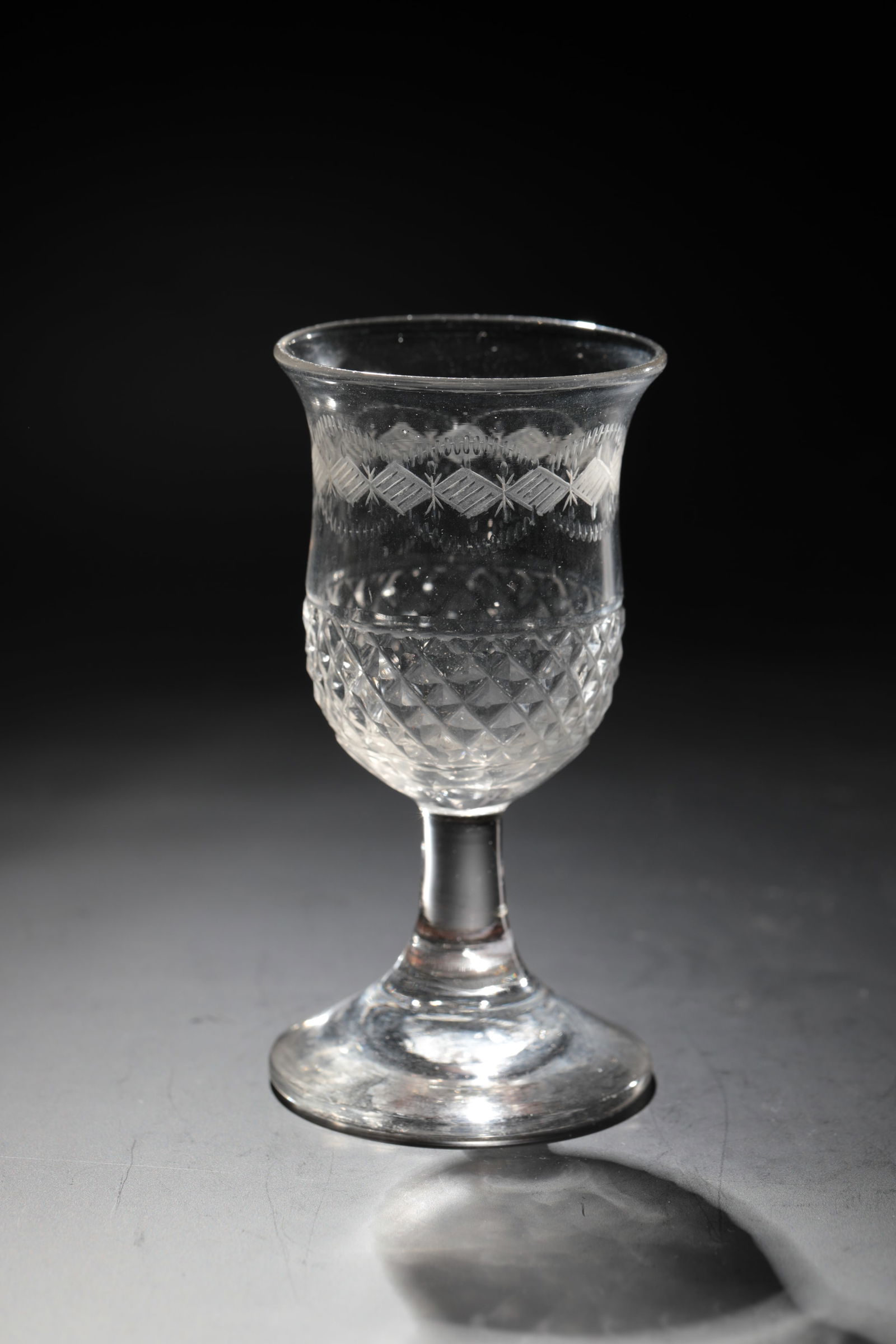 Small Empire Cup: Small Empire goblet Bohemia, c. 1820 Colourless glass with tear-off. Foot merging into shaft. Attachment of the bell-shaped cuppa with stone declor. Below the lip edge, circumferential border in matt