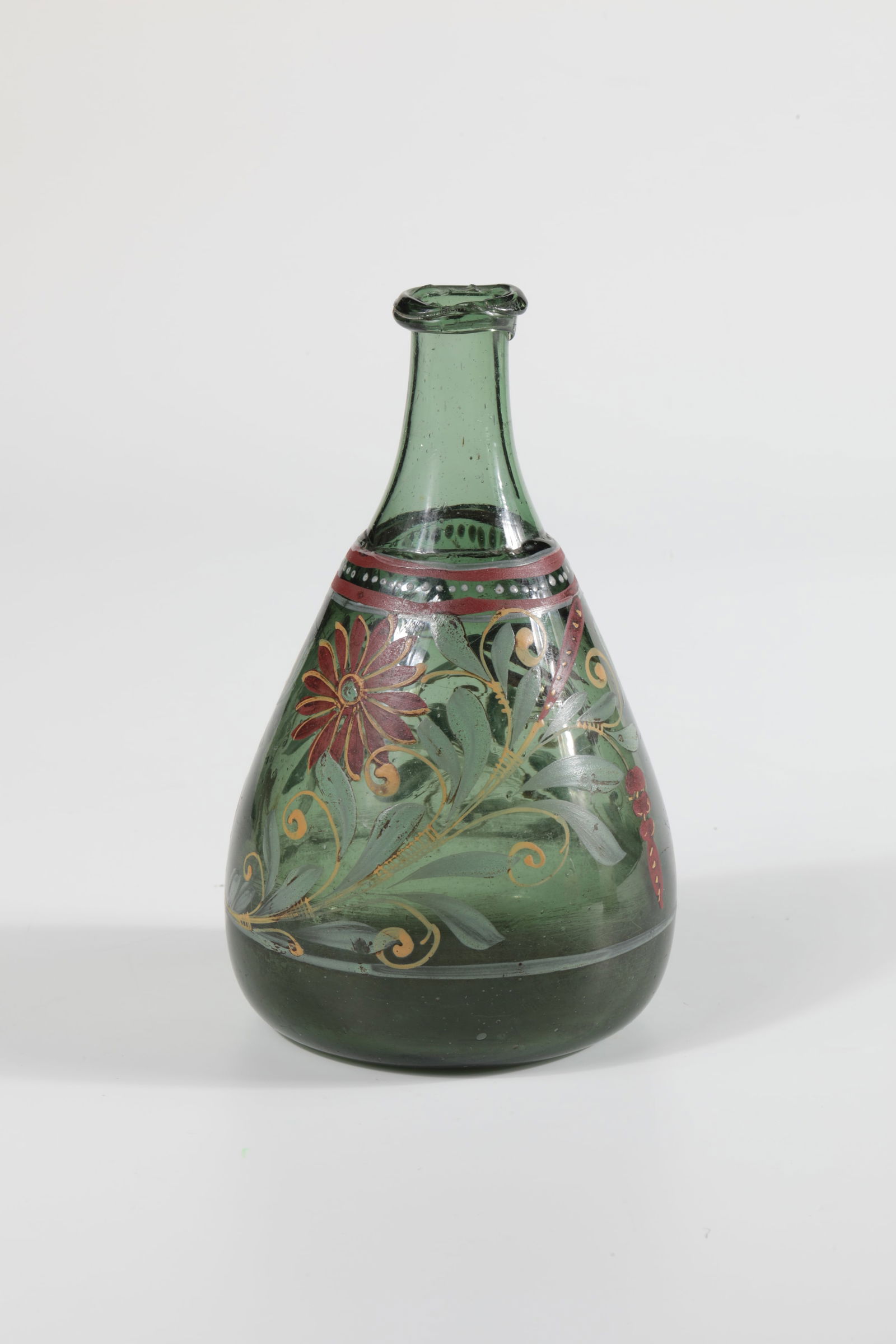 Rare Bottle: Rare bottle of Russia, 18th century. Green glass with tear-off. Lofty ground. On the club-shaped wall, circumferential enamel decoration: flowers, buds and leaves of the tulip and daisite in green, ye