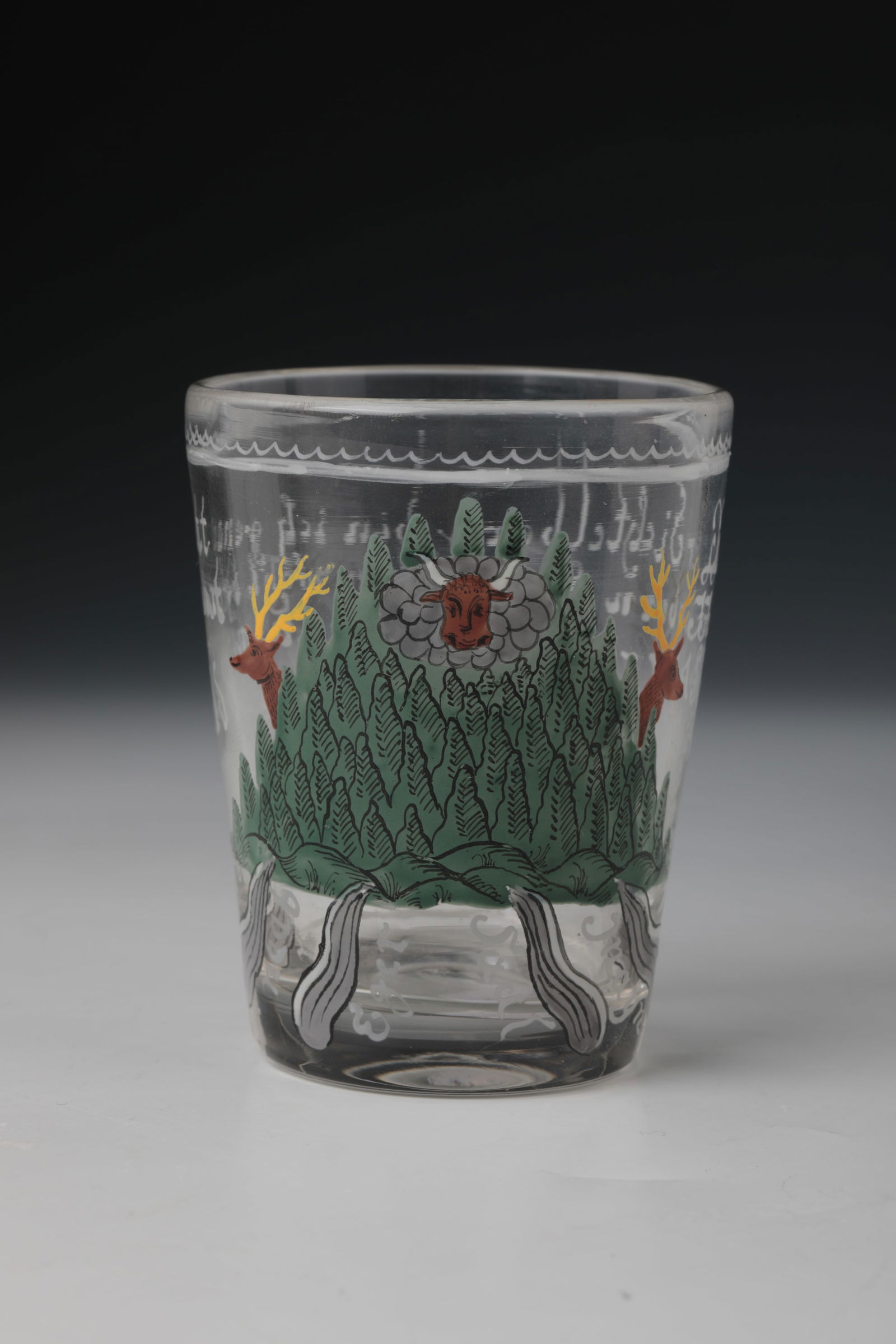 Ox Head Mug: Ochsenkopf beaker German, 19th century Colourless glass with slightly raised bottom and polished demolition. On the widened wall in colourful enamel painting a depiction of an ox's head with deer and