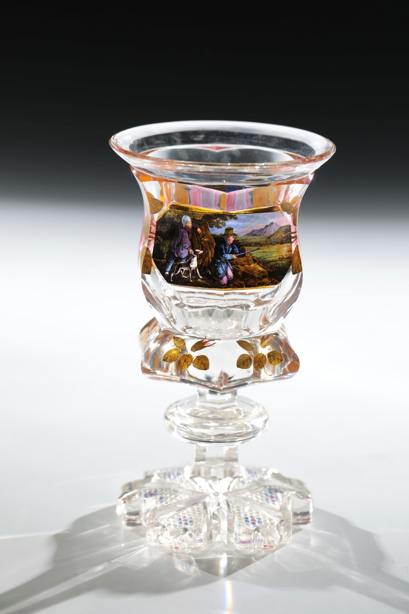 Cup with hunting motif: Goblet with hunting motif Gräflich Harrach'sche Glasfabrik, Neuwelt, c. 1840 Colourless glass. Multi-pass ground foot with stone cut décor, partly painted blue and red to create flower motifs. Facet
