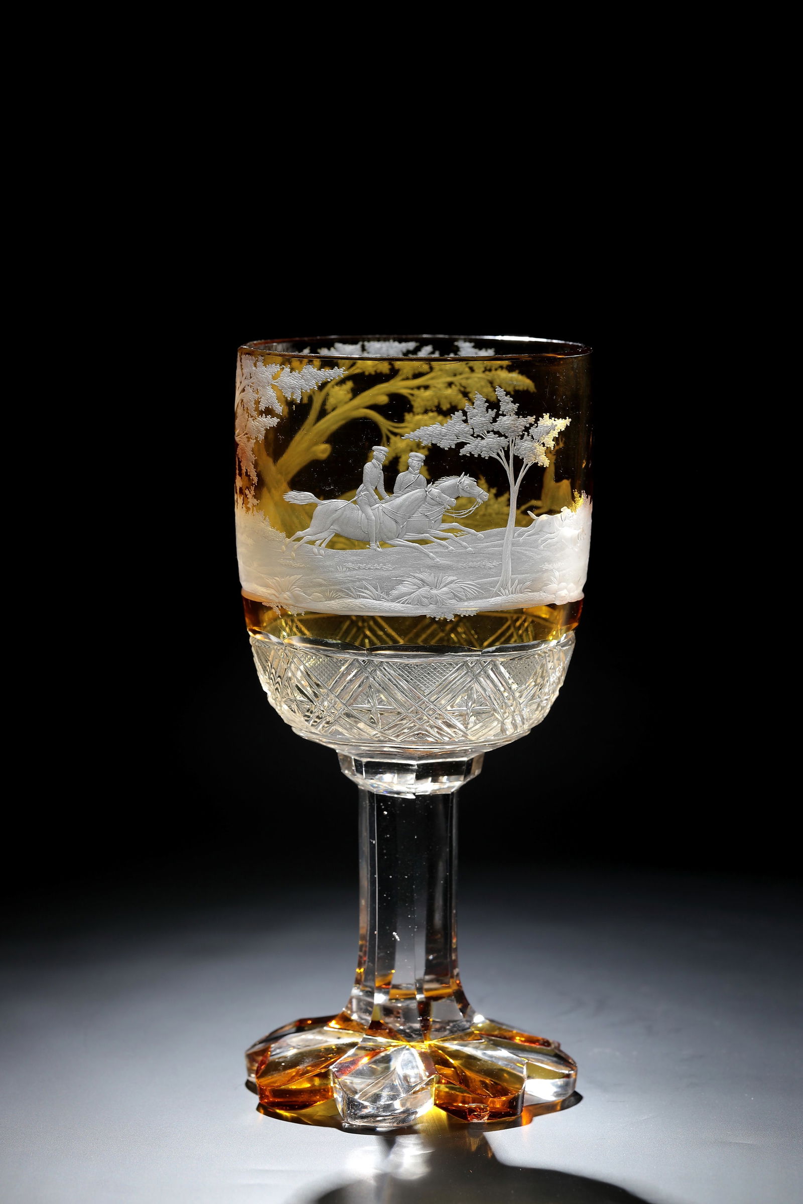 Hunting Cup: Hunting cup Bohemia, Emanuel Hoffmann (attributed), Karlsbad, c. 1860 Colourless, partially amber-coloured glazed glass. Octagonal foot bumped. Faceted shaft, the base of the cuppa decorated with