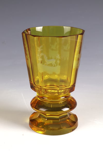 Foot cup: Foot cup Bohemia, mid-19th century Colourless, amber-coloured glazed and cut decorated glass. Surrounded by four cut animal representations in front of a forest landscape: deer, roe deer, hare and hor