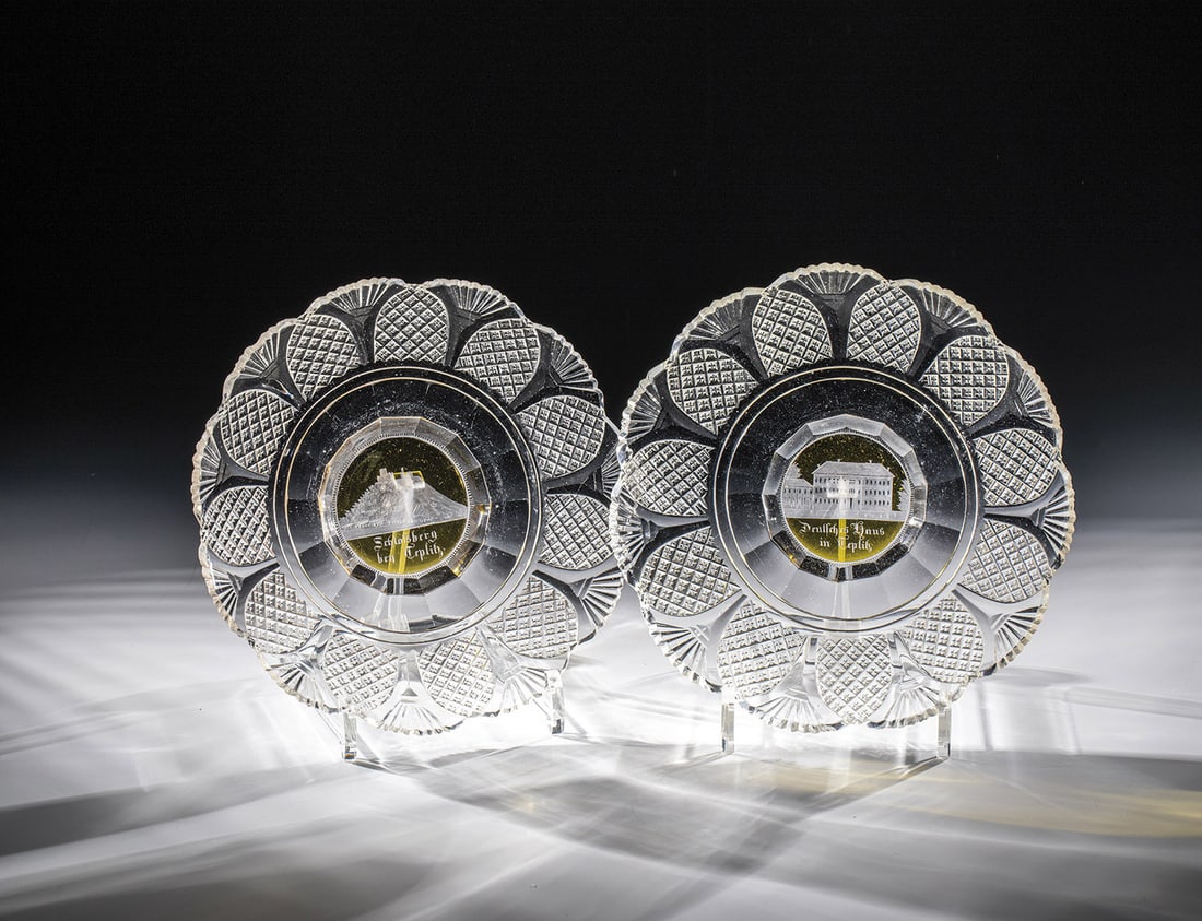 Two plates with a view of Teplice: Two plates with a view of Teplice Bohemia, around 1840 Colourless, richly cut glass. Flag yellow glazed and with a cut view each inscribed ''Deutsches Haus in Teplitz'' and ''Schloßsberg bey