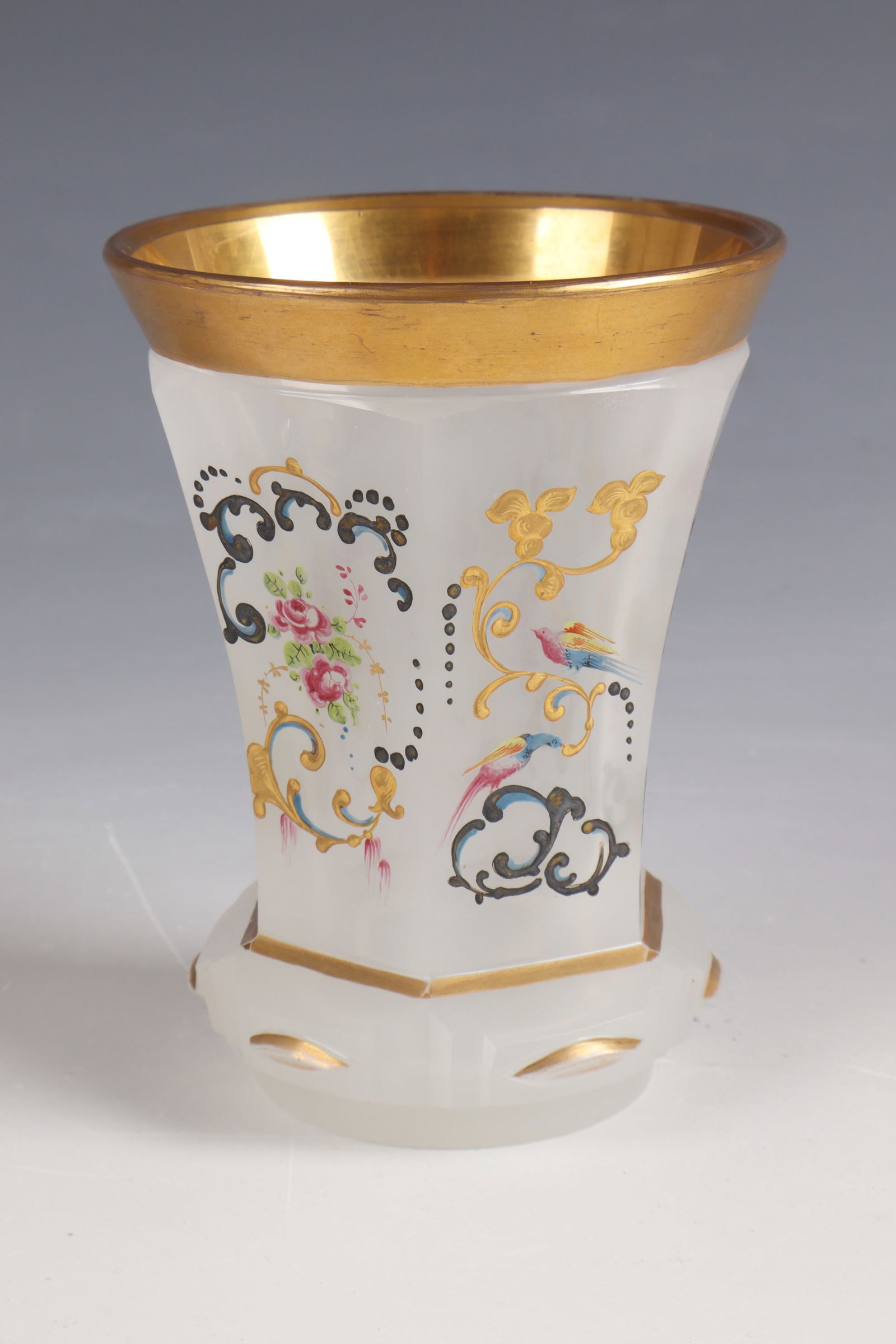 Mug: Beaker Bohemia, c. 1835 White, faceted alabaster glass with expansive stand. All around in polychrome enamel painting as well as silver and gold ornamental tendril decoration, flowers and bird
