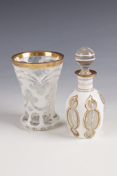 Bottle with stopper and mug: Bottle with stopper and mug Bohemia, c. 1860 Colourless glass with tin enamel overlay, cut decoration and gold painting. H. 12.5 or 14 cm