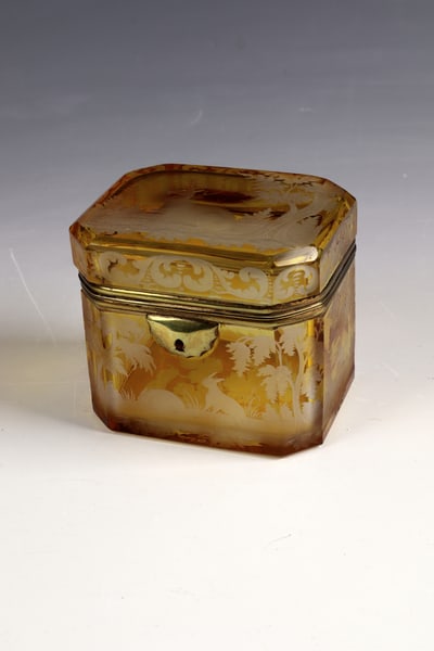 Lidded jar: Lidded box Bohemia, c. 1860 Colourless, yellow glazed glass. On the rectangular body and lid there is a forest landscape with animals: deer, hares and partridges. Vine cut in the ground.