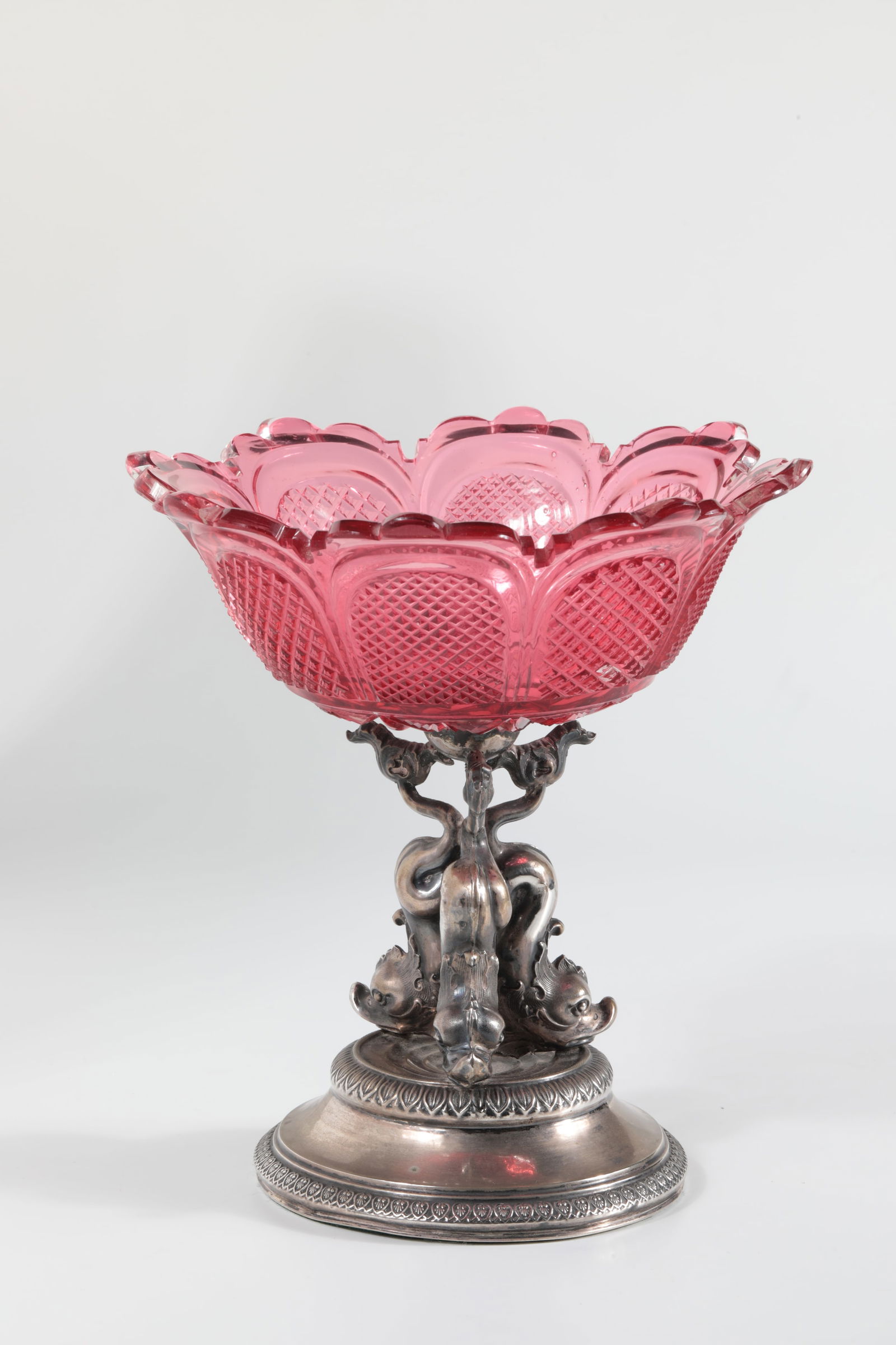 Top-mounted bowl with silver base: Top-mounted bowl with silver base mid-19th century Ruby red, cut glass on silver base with stylised dolphins. H. 18.5 cm.