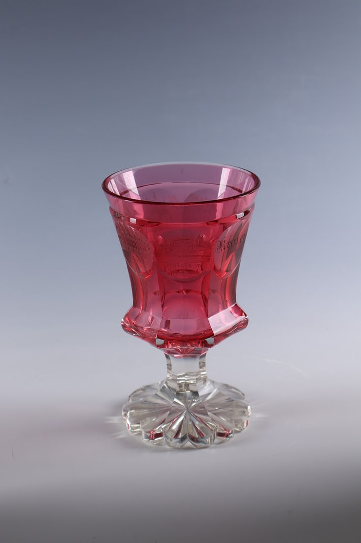Cup with views of Bad Pyrmont: Goblet with views of Bad Pyrmont Bohemia, c. 1840 Colourless, faceted glass. On the cuppa, underpinned with ruby glass, six cut and inscribed views of Bad Pyrmont as well as the name inscription ''Kro