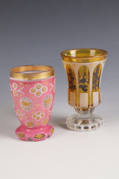 Two foot cups: Two foot cups, end of the 19th century, colourless glass with ornamentally cut pewter enamel overlay and gold-yellow underlay, floral decoration in silver and gold all around. H. 14 cm. Colourless