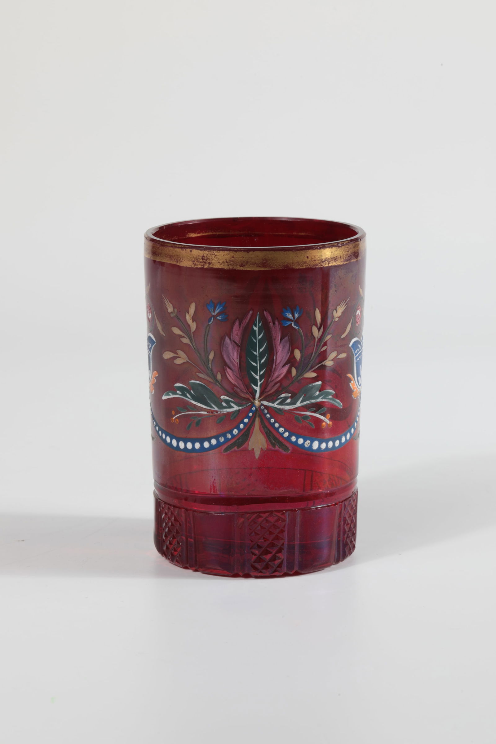 Cylinder cup: Cylinder beaker North Bohemia, Kreibitz or Falkenau, c. 1830 Colourless glass, decorated with cut border on the stand, ruby red glazed. Polychrome painted floral border with flower vases and beaded