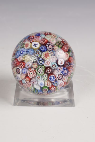 Paperweight with silhouettes: Paperweight with silhouettes Baccarat, dated 1848 On white muslin round flower cushions made of various colourful millefiori sticks as well as silhouette canes with rooster, horse and monkey.