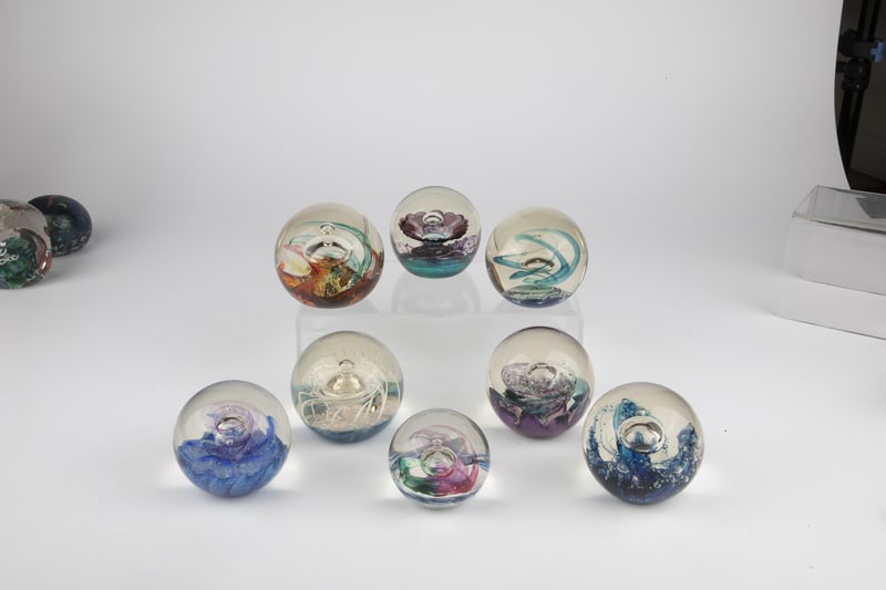 Eight paperweights: Eight paperweights Selkirk Glass, Scotland, 20th century Eight glass paperweights with bubbles decoration. 7 of 8 with original label ''Selkirk Glass''. Signed on the bottom ''Snow Queen 250500