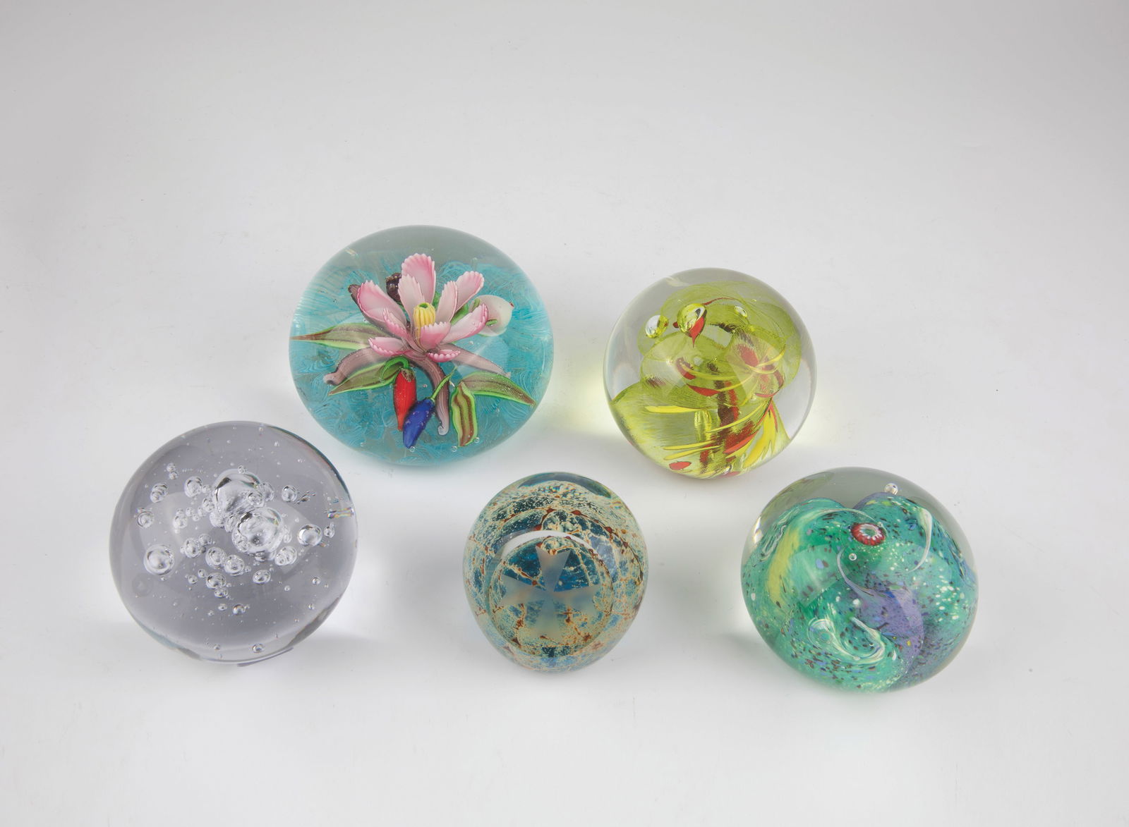 Five Paperweights: Five paperweights 20th/21st century Five glass paperweights, two with original label ''Hut Princ Art Glass'' and ''Wolf Sigodeluxe'' and three signed on the bottom ''Mdina'' by Mdina Glass, ''Veni'' a