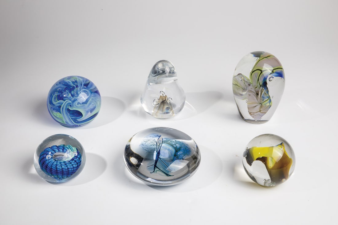 Six paperweights: Six paperweights, 20th century, mixed lot of six paperweights. Two Fusion Glass Paperweights with original label, one of them also signed on the bottom ''Fusion Glass''. Three with signature on the