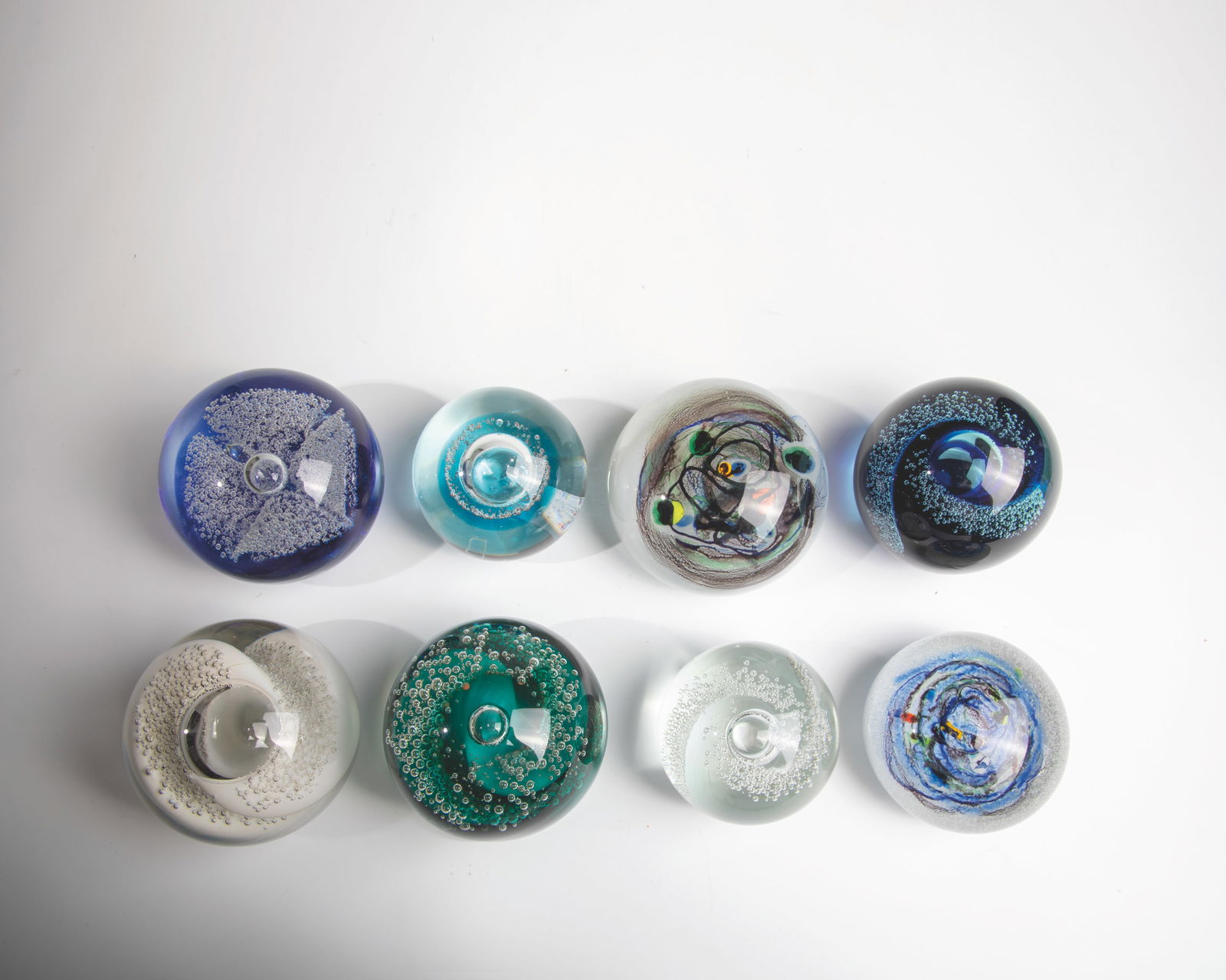 Eight paperweights: Eight paperweights 20th century Eight paperweights made of glass, mostly with enclosed air bubbles in various sizes, and with the signature ''Be''. W.7-10cm H.5-9cm.