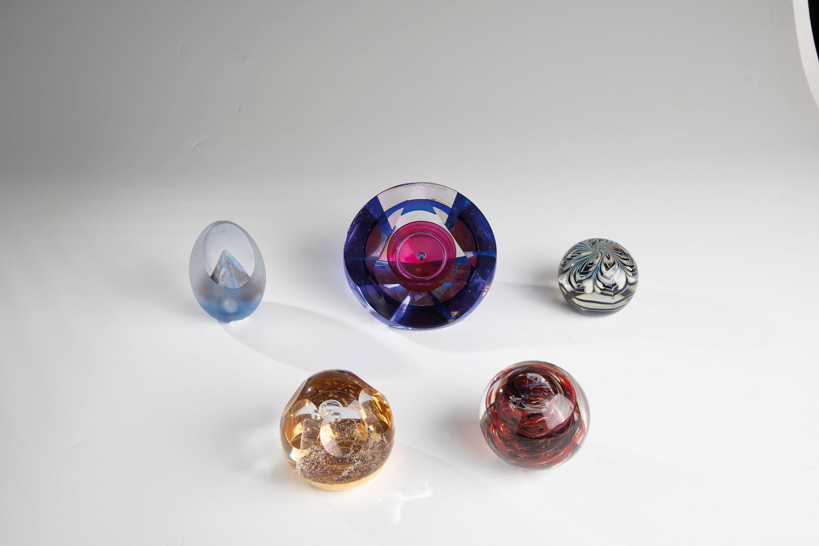 Five Paperweights: Five paperweights 20th century Two paperweights from Glaskunst Pfeiffer with original label ''Brillant Kristal Pfeiffer Handmade Holland'' as well as two paperweights from Orrefors Sweden, one with