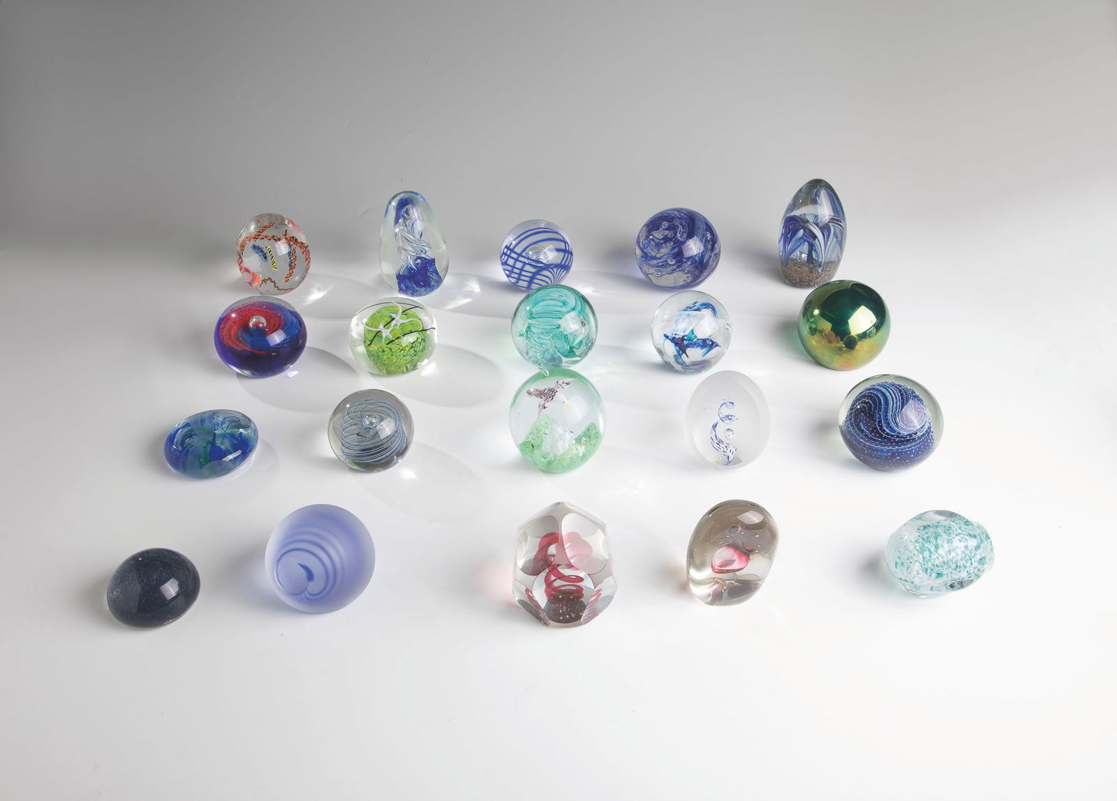 Twenty Paperweights: Twenty paperweights 20th century Twenty glass paperweights with different motifs and without signature. D.6.5-8.7cm H.4.5-11.3cm.